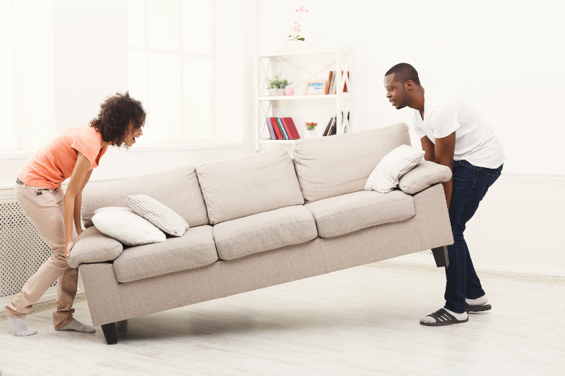 planitar couple placing sofa at new home PPDK3MW